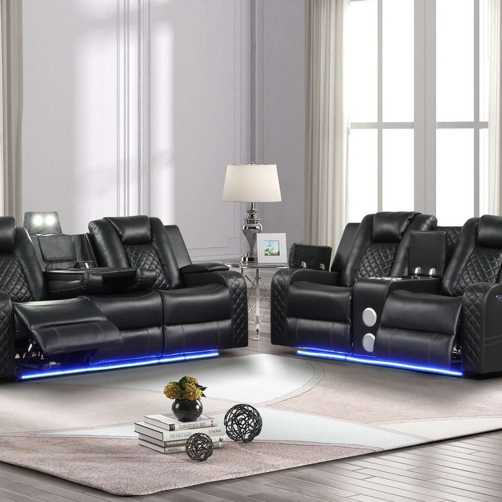 Benz Black Leather Reclining Sofa Set: The Ultimate in Modern Comfort Elevate Your Living Room with Our Power Recliner Black Leather Sofa The Benz Black Leather Reclining Sofa Set redefines relaxation with its ultra-cool, contemporary design. This modern black leather sofa combines cutting-edge technology with luxurious comfort, making it the perfect centerpiece for any modern living space. Key Features of Our Black Leather Reclining Sofa Set: Fabulous faux leather upholstery with pebbled effect One-touch power control with adjustable headrest Unique LED lights for ambient illumination Love seat with built-in console and Bluetooth speaker Sofa with central reading light and convenient cupholders High-quality, durable solid wood construction Advanced Technology for Ultimate Relaxation This modern black sofa with LED lights offers more than just comfort. The one-touch power control allows effortless adjustment of reclining positions, while the adjustable headrest ensures perfect neck and head support. Entertainment at Your Fingertips The love seat's built-in console and Bluetooth speaker bring entertainment to your fingertips. Enjoy your favorite music or keep your essentials close at hand while you relax. Thoughtful Design for Modern Living The Benz set isn't just about comfort; it's designed for modern lifestyles. The black leather sofa with power headrest features a central reading light for late-night reading without disturbing others, while convenient cupholders keep your drinks within reach. Ambient Lighting for the Perfect Mood Create the perfect atmosphere with unique LED lights located at the bottom of each piece, adding a touch of modernity and elegance to your space. Durable Construction for Lasting Enjoyment Crafted with solid wood material, this modern sofa with phone charger ensures durability and longevity. Its high-quality construction guarantees years of comfort and style. Experience the perfect blend of technology and comfort with the Benz Black Leather Reclining Sofa Set. Its striking design and advanced features make it an ideal choice for those seeking a modern, luxurious living room experience. Looking for more options? Check out our selection of reclining sofa sets to find the perfect match for your home. Transform your living room into a haven of comfort and style with the Benz Black Leather Reclining Sofa Set. Embrace the future of relaxation with this exceptional power recliner black leather 2 pc sofa and loveseat