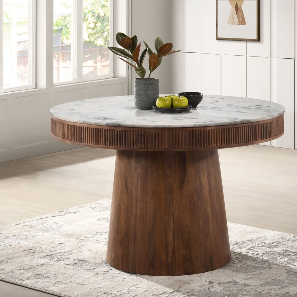 Front view of the Ortega 46-inch round table with white marble top | Three-quarter view showing the fluted mango wood pedestal | Close-up of the genuine white marble veining | Detail of the vertical fluting on the pedestal | Top-down view of the 46-inch round marble top | Close-up of the natural mango wood grain | Detail of the marble-to-wood transition | Room scene with the Ortega table in a dining nook
