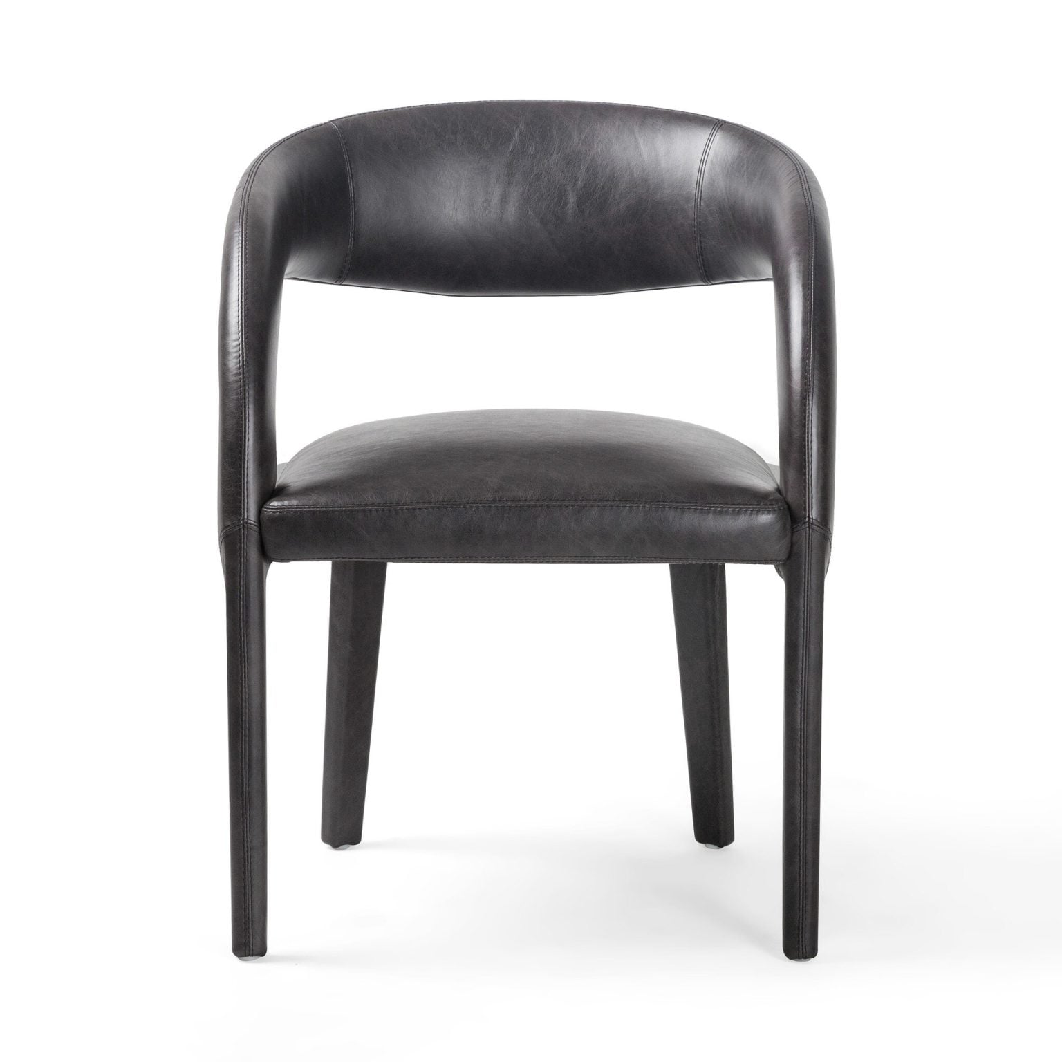 Front view of the Hawkins dining chair in Sonoma Black top-grain leather | Three-quarter view showing the sculpted armed silhouette | Side profile of the Hawkins leather chair, 31 inches tall | Room scene with the Hawkins chair as an accent piece | Close-up of the Sonoma Black leather grain | Rear view of the Hawkins dining chair | Detail of the sculpted arm and back craftsmanship | Close-up of the leather upholstery finish | Detail of the Hawkins' tailored seams | Close-up of the black leather texture in natural light