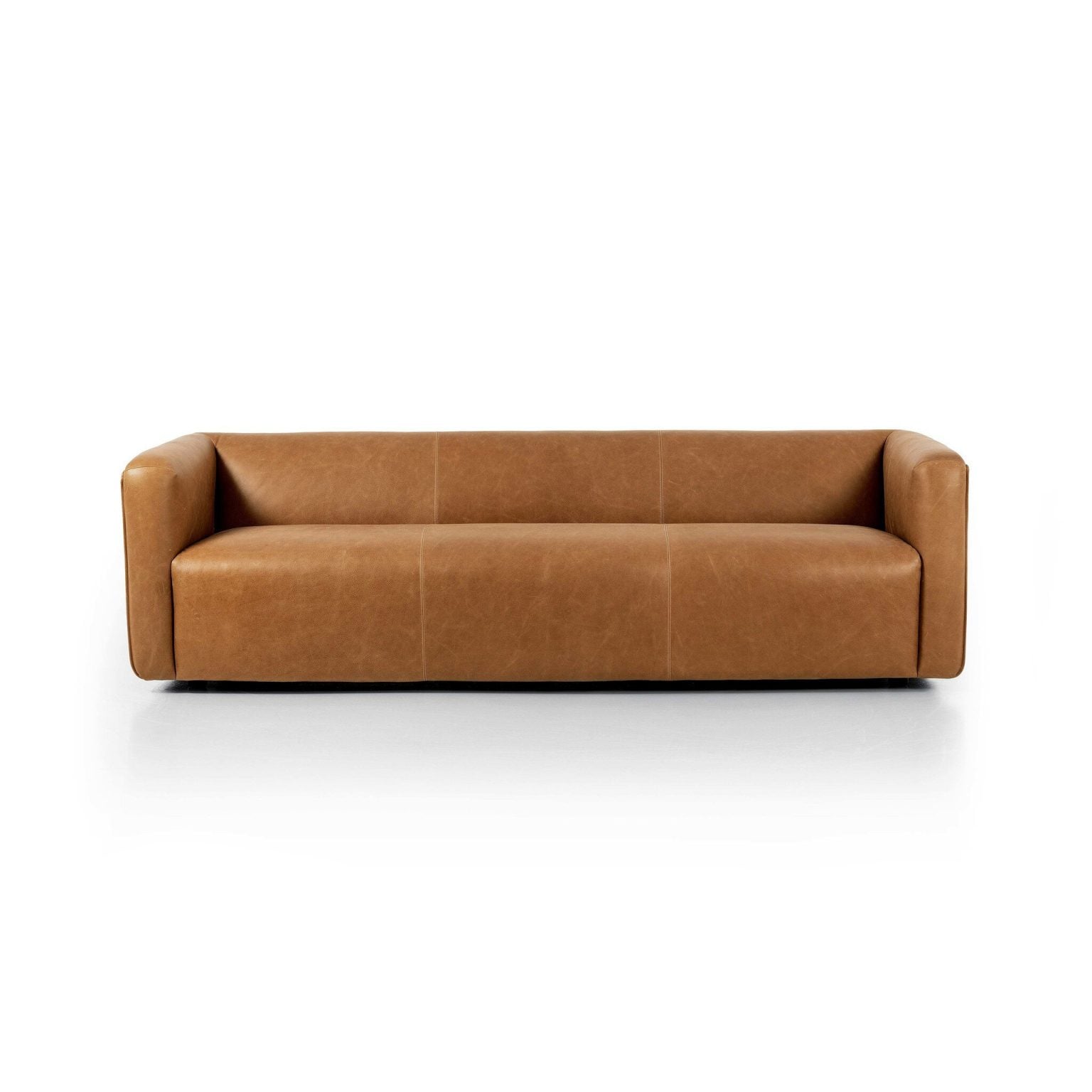 Front view of the Wellborn 97-inch sofa in Palermo Cognac thick-cut top-grain leather | Three-quarter view of the Wellborn cognac leather sofa showing the 1970s low profile | Side profile of the Wellborn leather sofa highlighting the structured frame | Room scene with the Wellborn cognac leather sofa in a styled living room | Close-up of the Palermo Cognac warm brown leather grain and tonal variation | Rear view of the Wellborn 97-inch top-grain leather sofa | Detail of the Wellborn's subtly distressed leather finish | Close-up of the Wellborn's cushion plushness and seam work | Detail of the leather burnishing on the Wellborn's arm | Close-up of the Wellborn's seat cushions in Palermo Cognac | Detail of the Wellborn's 1970s-inspired leg and base | Close-up of the thick-cut leather edge on the Wellborn | Detail of natural creasing in the Wellborn's top-grain leather | Close-up of the Palermo Cognac color depth in natural light | Detail view of the Wellborn's back cushions and tailored finish