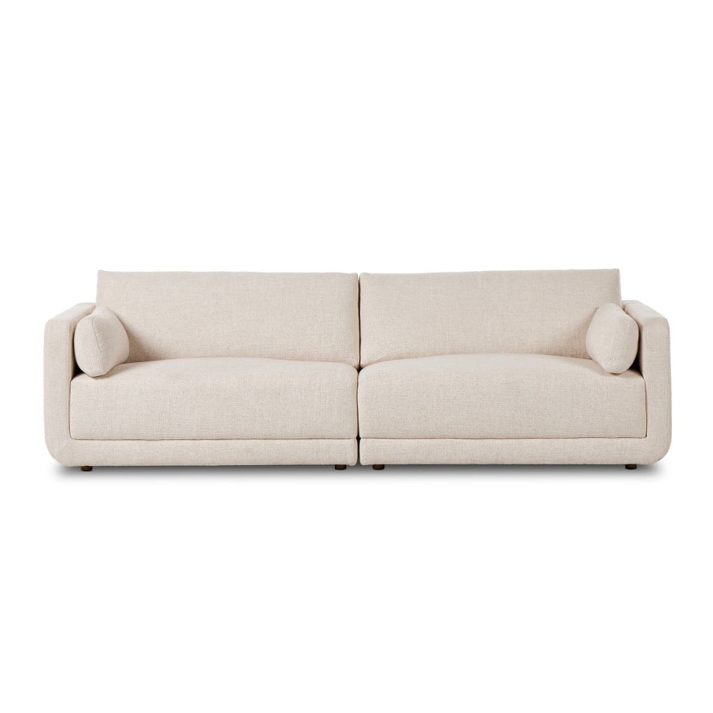 Front view of the Toland 2-piece modular sectional in Palma Cream basketweave with shelter arms | Three-quarter view of the Toland cream basketweave sectional showing the linear base and loose back cushions | Side profile of the Toland modular sectional highlighting the shelter arm silhouette | Close-up of the Palma Cream basketweave upholstery texture on the Toland sectional | Rear view of the Toland 2-piece sectional in cream basketweave | Detail of the Toland's tailored back cushions in Palma Cream fabric | Close-up of the weathered ash wood accent along the Toland's base | Detail of the Toland's shelter arm and cushion tailoring | Close-up of the Toland's seat cushion and basketweave texture | Detail view of the Toland sectional's modular joinery