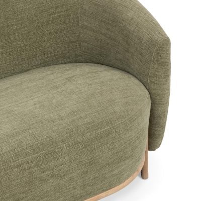 Myra barrel sofa in sage dust green polyester, close-up of the curved barrel back