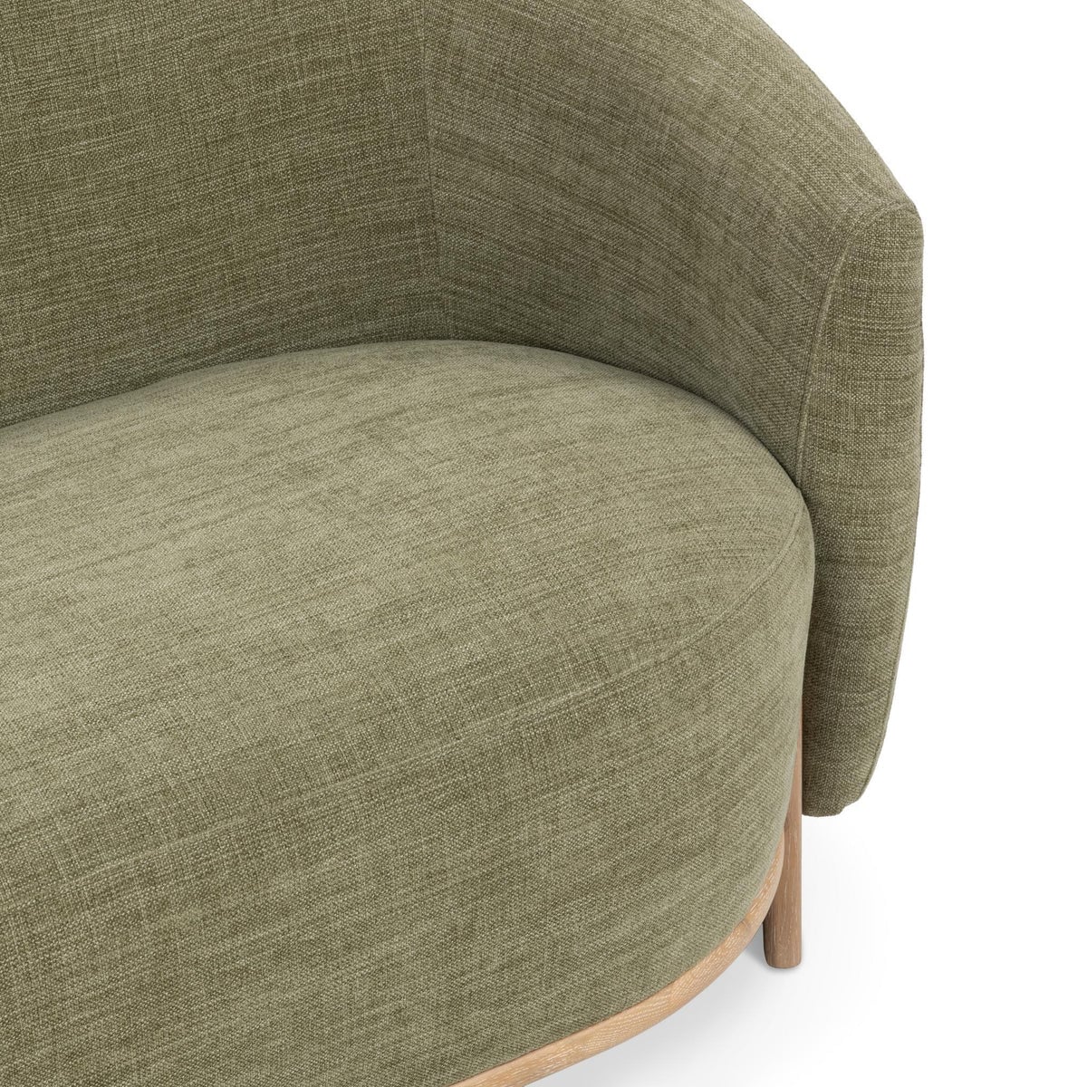 Myra barrel sofa in sage dust green polyester, close-up of the curved barrel back