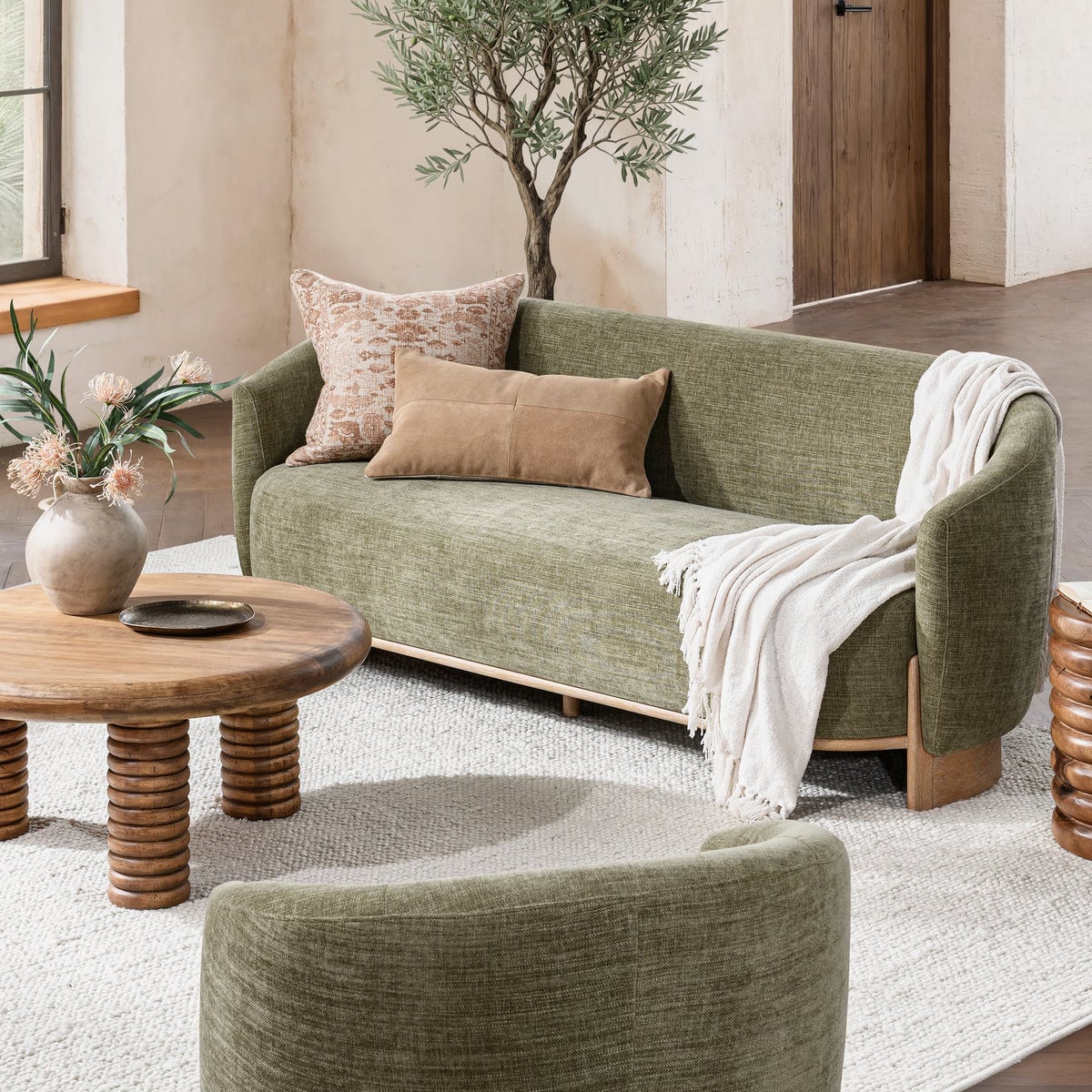 Myra barrel sofa in sage dust green polyester, styled in a living room setting