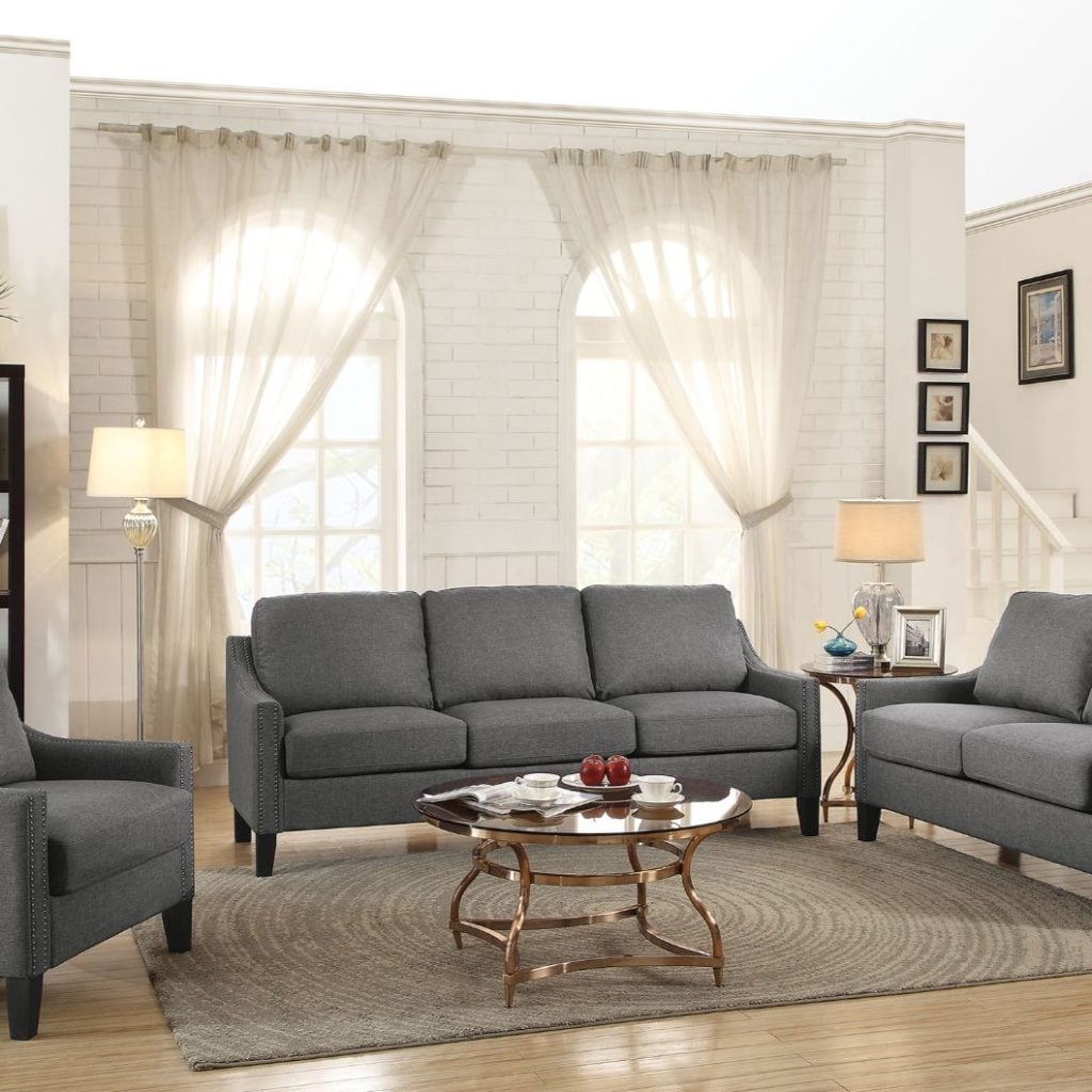 Zapata grey linen sofa with matching loveseat and accent chair in a bright living room
