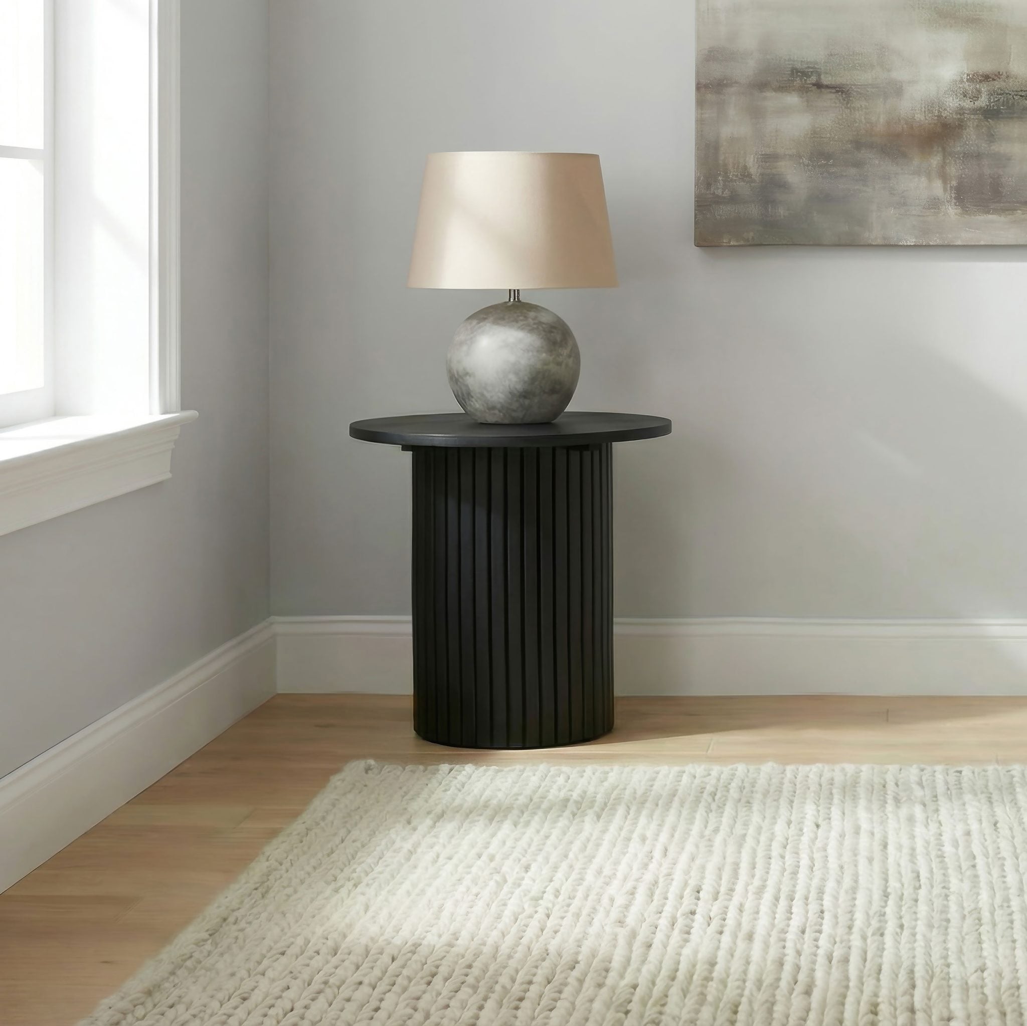 Hamlyn round fluted end table in black wood, front view