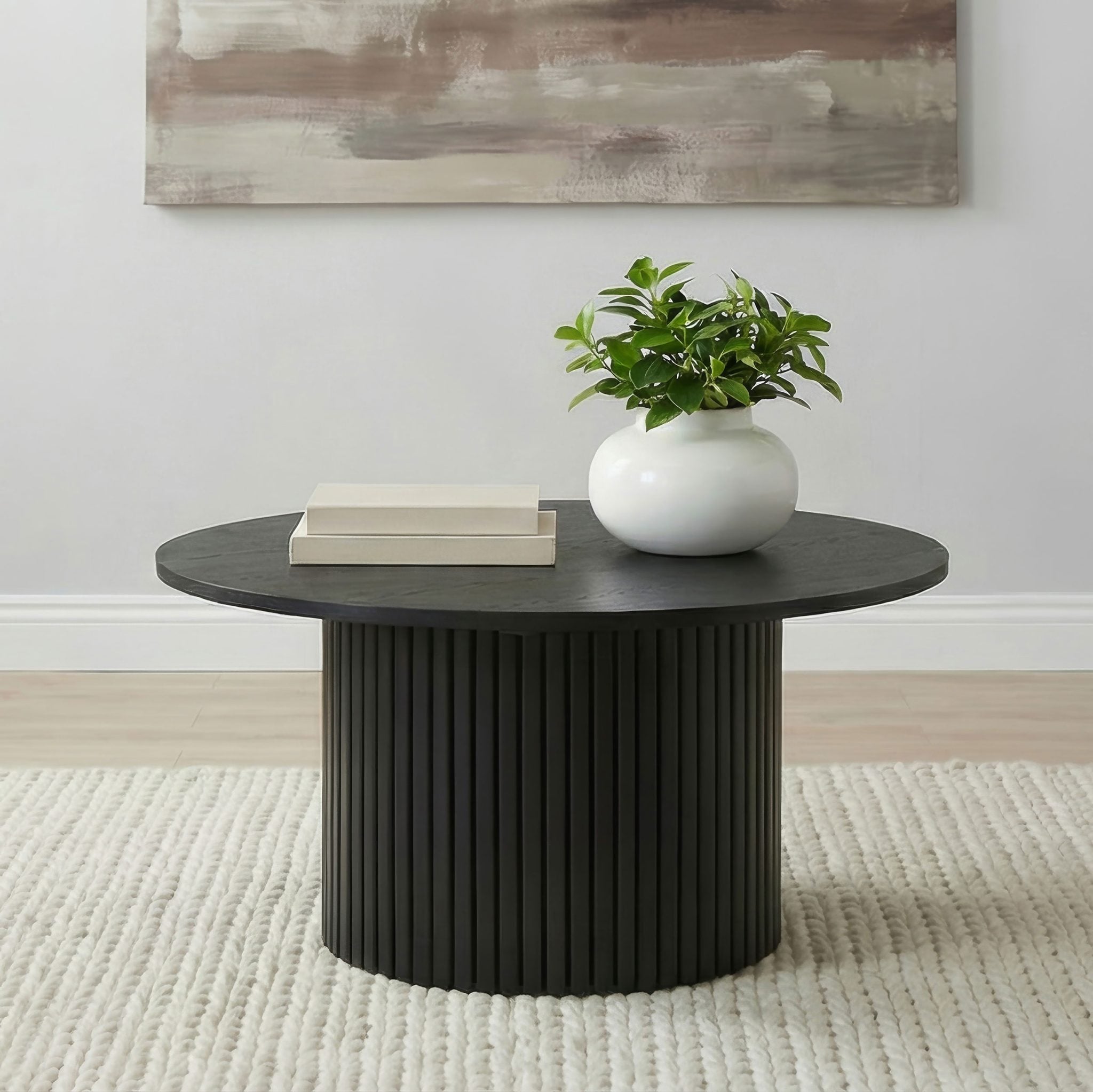 Hamlyn round fluted coffee table in black wood, front view