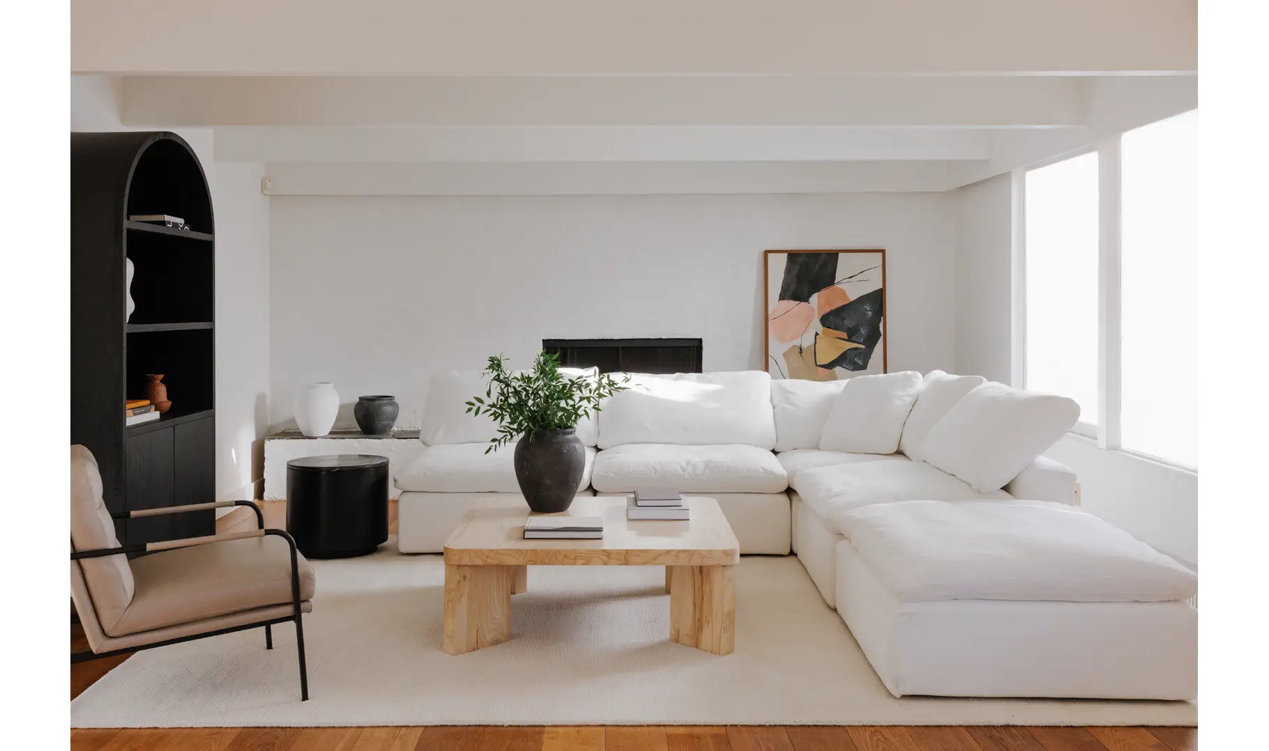 White cloud sectional with a green plant on the coffee table